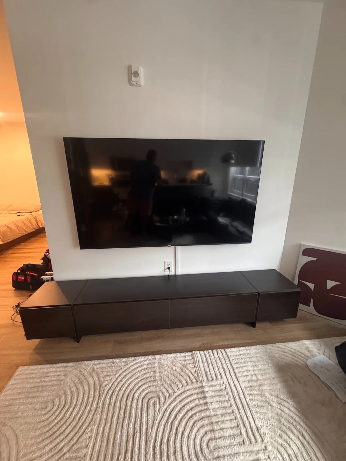 Large TV mounted above a long media console by Assemble Pro NJ